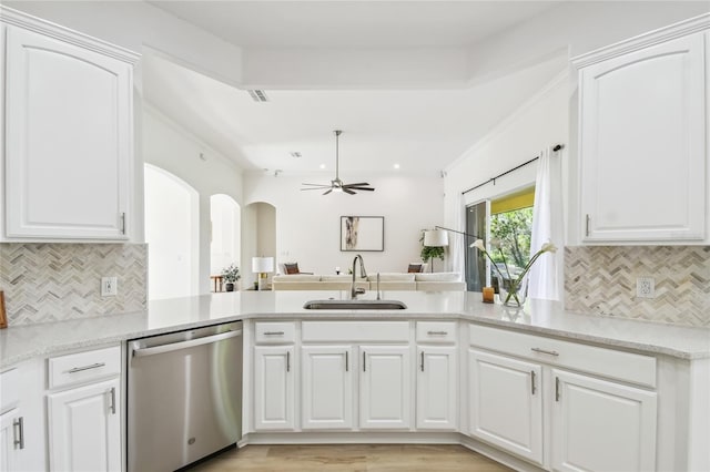 517 Milano Rd, Poinciana, FL 34759 - kitchen featuring a sink, dishwasher, a peninsula, arched walkways, and a ceiling fan