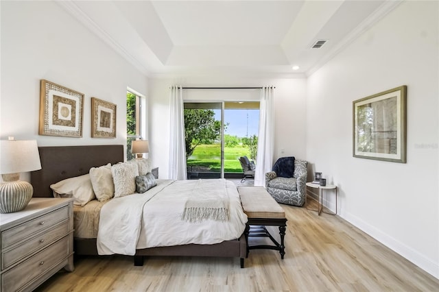 517 Milano Rd, Poinciana, FL 34759 - bedroom with light wood finished floors, a raised ceiling, access to exterior, crown molding, and baseboards