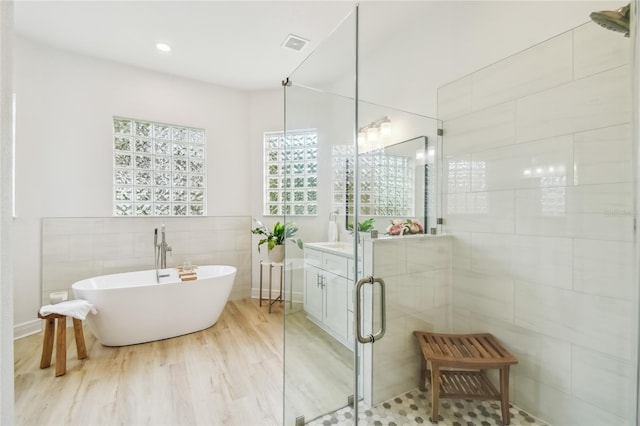 517 Milano Rd, Poinciana, FL 34759 - bathroom with tile walls, a soaking tub, a shower stall, and recessed lighting