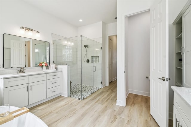 517 Milano Rd, Poinciana, FL 34759 - full bath with a shower stall, vanity, wood finished floors, and baseboards
