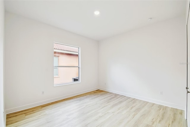 517 Milano Rd, Poinciana, FL 34759 - spare room featuring light wood finished floors, baseboards, and recessed lighting