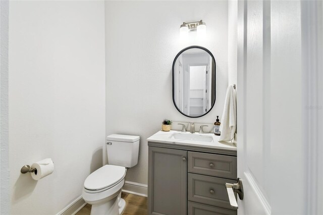 517 Milano Rd, Poinciana, FL 34759 - bathroom with toilet, baseboards, vanity, and wood finished floors