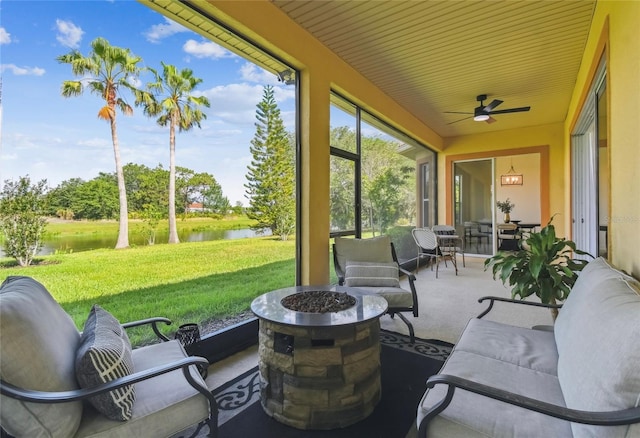 517 Milano Rd, Poinciana, FL 34759 - sunroom featuring a water view, a ceiling fan, and an outdoor living space with a fire pit