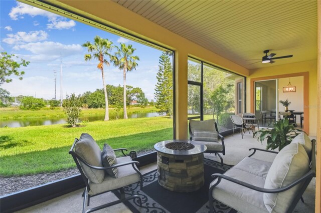 517 Milano Rd, Poinciana, FL 34759 - sunroom / solarium featuring a water view, ceiling fan, and an outdoor living space with a fire pit