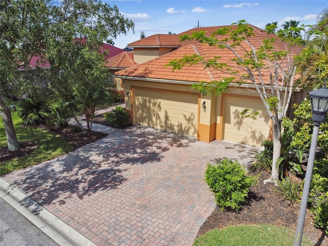 517 Milano Rd, Poinciana, FL 34759 - view of front of property with stucco siding, a tile roof, decorative driveway, and an attached garage