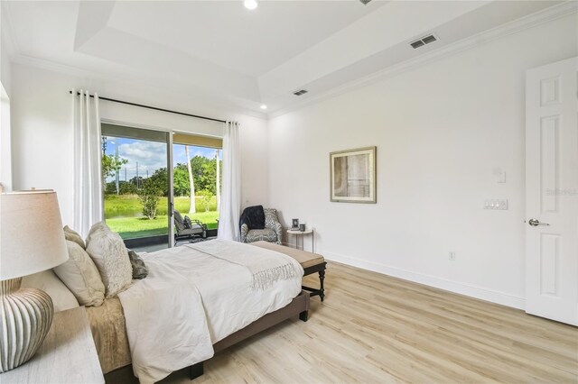 517 Milano Rd, Poinciana, FL 34759 - bedroom featuring access to outside, ornamental molding, light wood-style floors, a raised ceiling, and recessed lighting
