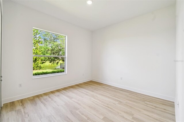 517 Milano Rd, Poinciana, FL 34759 - empty room featuring light wood-style floors, baseboards, and recessed lighting
