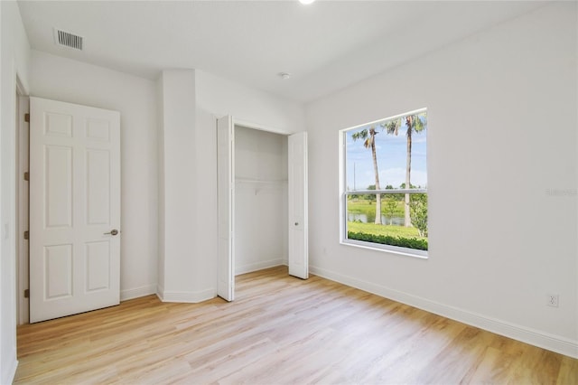 517 Milano Rd, Poinciana, FL 34759 - unfurnished bedroom featuring light wood-style flooring and baseboards