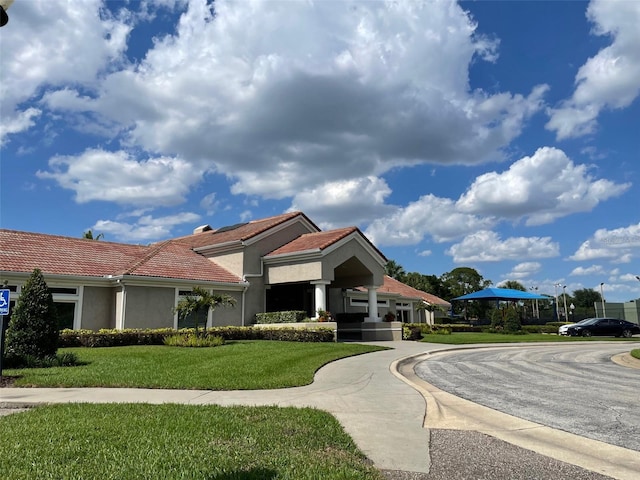 7200 Green Pine Ct, Orlando, FL 32819 - view of front of home featuring stucco siding, a tile roof, and a front yard