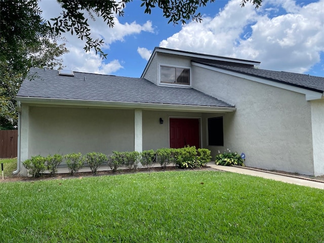 7200 Green Pine Ct, Orlando, FL 32819 - view of front of property with a front yard, a shingled roof, and stucco siding