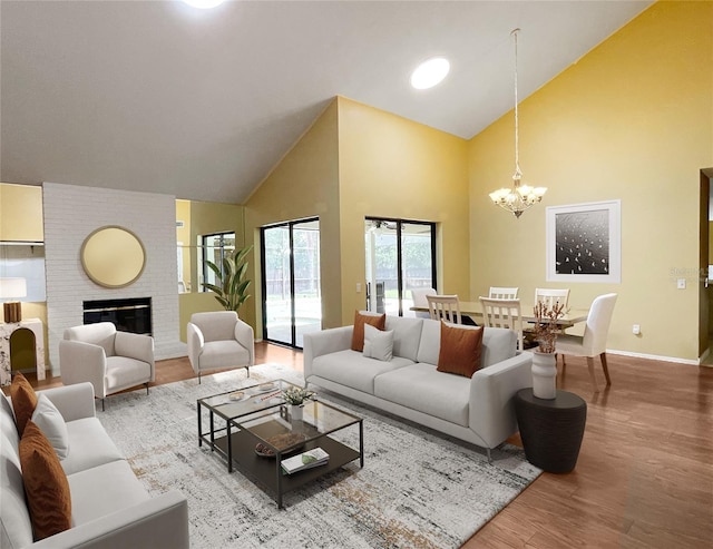 7200 Green Pine Ct, Orlando, FL 32819 - living area with high vaulted ceiling, wood finished floors, a chandelier, and a fireplace