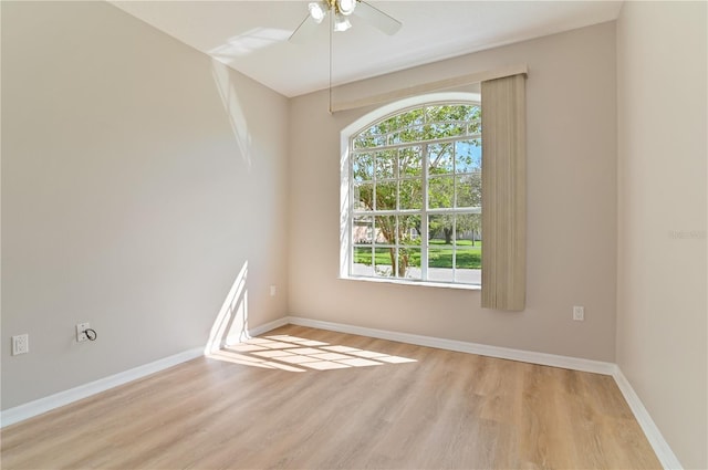 unfurnished room featuring wood finished floors, ceiling fan, and baseboards