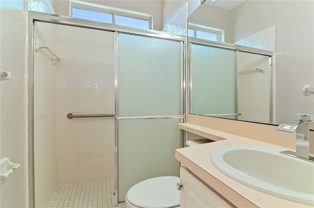 full bath featuring a stall shower, toilet, and vanity