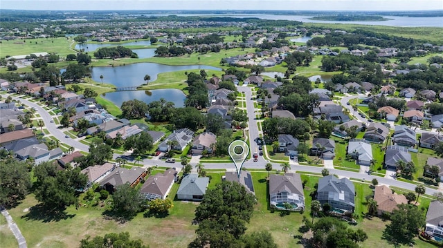 aerial overview of property's location with a nearby body of water and nearby suburban area