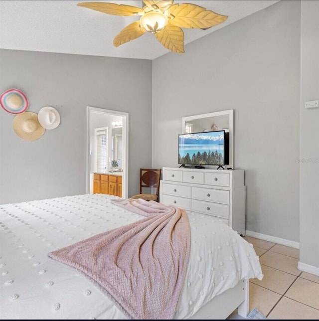 2567 Oneida Loop, Kissimmee, FL 34747 - bedroom featuring light tile patterned flooring, baseboards, lofted ceiling, ceiling fan, and connected bathroom