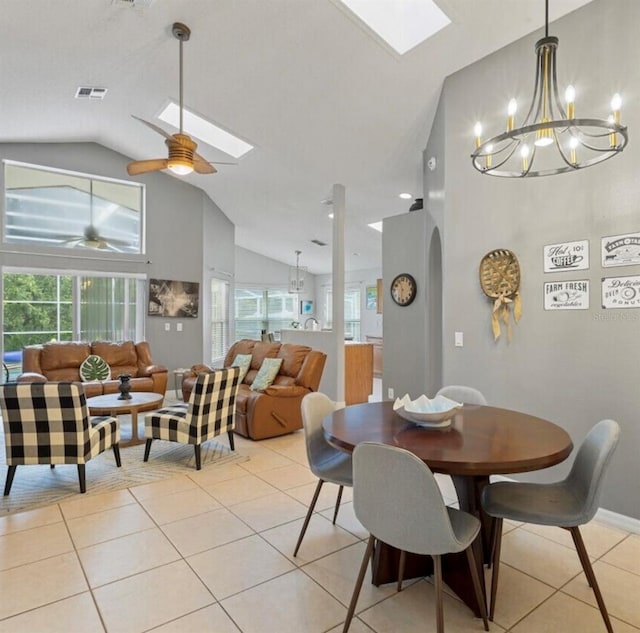 2567 Oneida Loop, Kissimmee, FL 34747 - dining space featuring a skylight, light tile patterned flooring, high vaulted ceiling, a chandelier, and arched walkways
