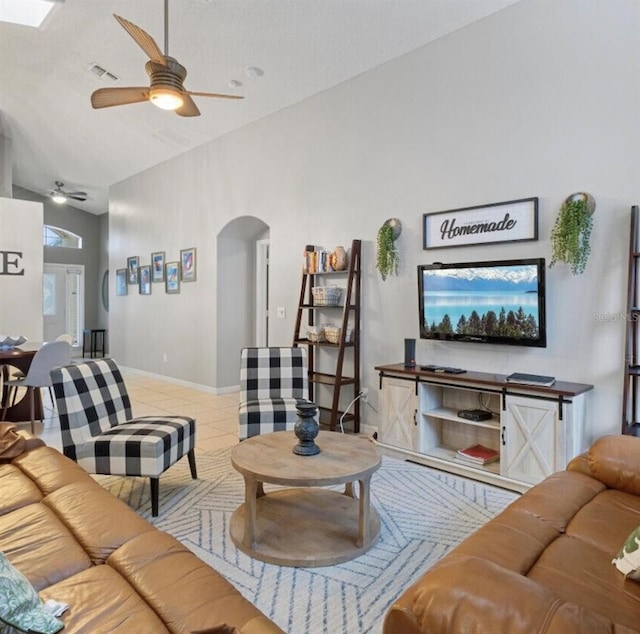 2567 Oneida Loop, Kissimmee, FL 34747 - tiled living room featuring arched walkways, ceiling fan, and baseboards