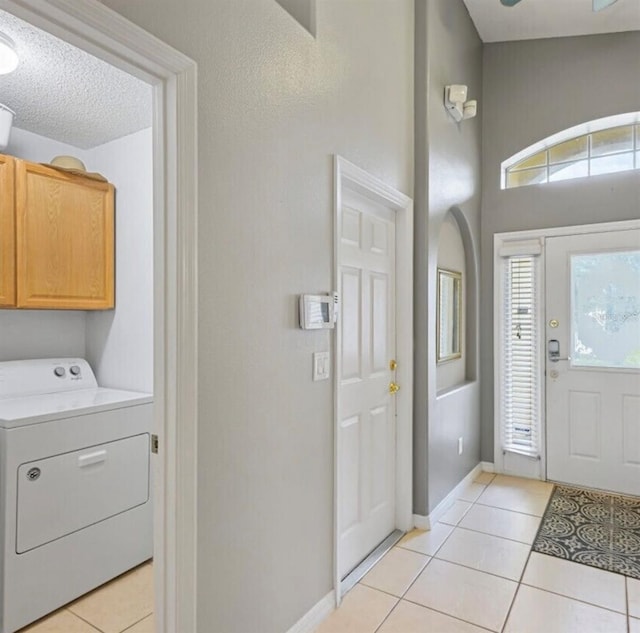 2567 Oneida Loop, Kissimmee, FL 34747 - entryway with washer / clothes dryer, light tile patterned flooring, and baseboards