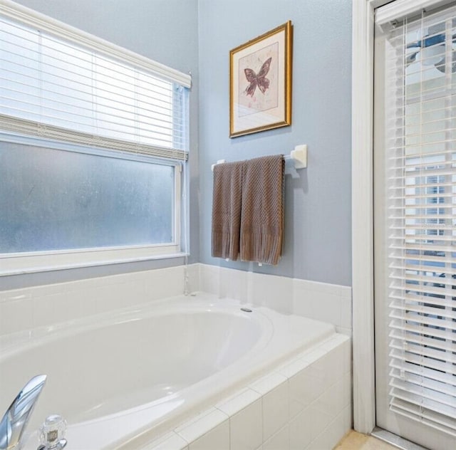 2567 Oneida Loop, Kissimmee, FL 34747 - full bathroom featuring a garden tub and plenty of natural light