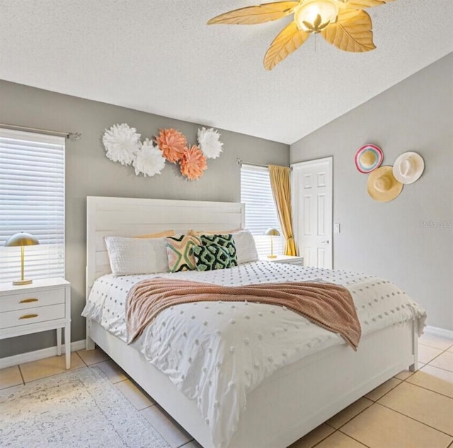 2567 Oneida Loop, Kissimmee, FL 34747 - bedroom with light tile patterned floors, a textured ceiling, ceiling fan, and baseboards