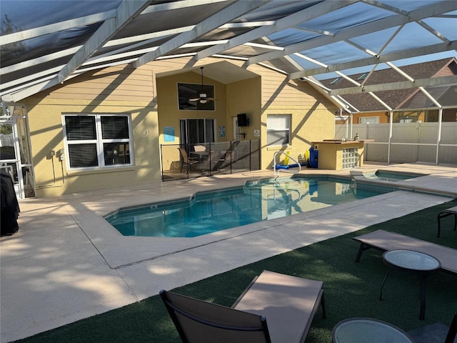 2567 Oneida Loop, Kissimmee, FL 34747 - view of swimming pool with a patio area, a ceiling fan, glass enclosure, outdoor dining area, and exterior bar