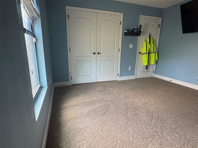18805 Nettleton St, Orlando, FL 32833 - unfurnished bedroom featuring a closet, carpet, multiple windows, and baseboards