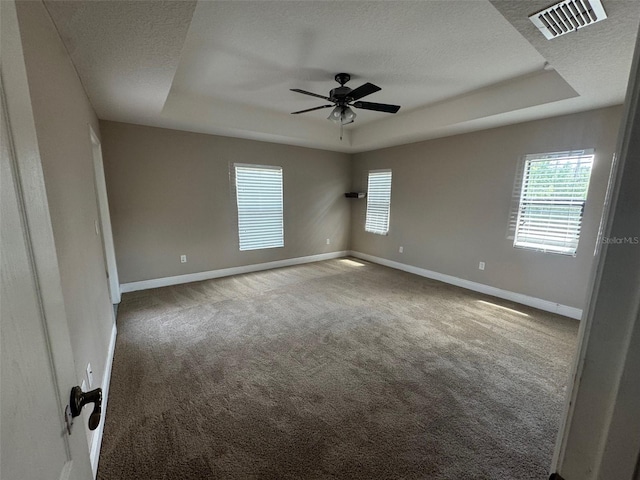 18805 Nettleton St, Orlando, FL 32833 - carpeted spare room featuring a tray ceiling, a textured ceiling, baseboards, and a ceiling fan