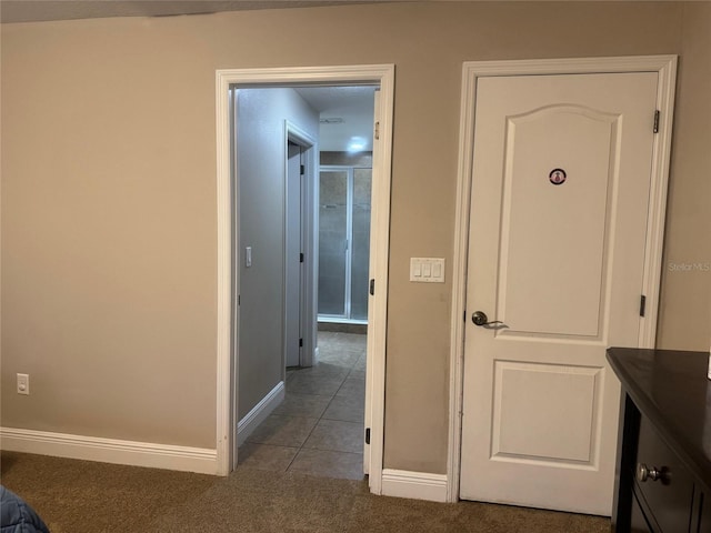 18805 Nettleton St, Orlando, FL 32833 - hallway with baseboards, carpet flooring, and tile patterned floors