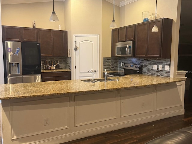 18805 Nettleton St, Orlando, FL 32833 - kitchen featuring appliances with stainless steel finishes, backsplash, dark brown cabinetry, a sink, and crown molding