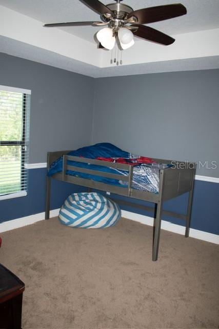 18805 Nettleton St, Orlando, FL 32833 - bedroom featuring carpet floors, baseboards, a ceiling fan, and a tray ceiling
