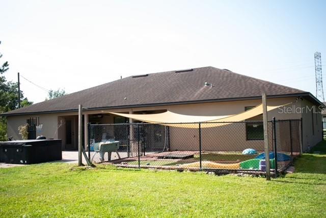 18805 Nettleton St, Orlando, FL 32833 - back of house featuring a hot tub