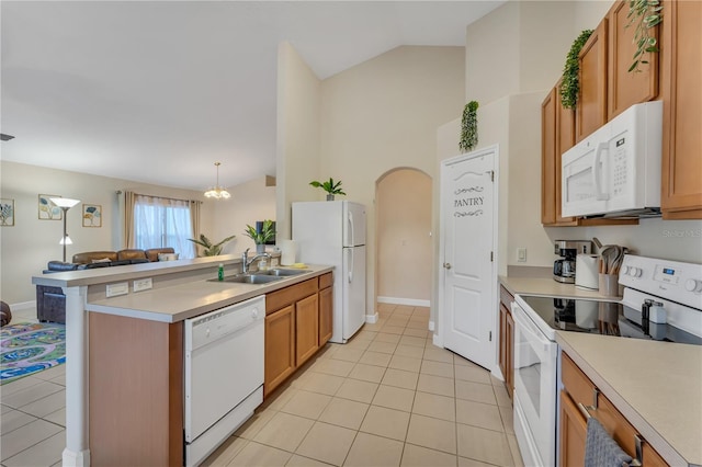 620 Old Bridge Cir, Davenport, FL 33897 - kitchen featuring white appliances, light tile patterned floors, a sink, open floor plan, and a peninsula