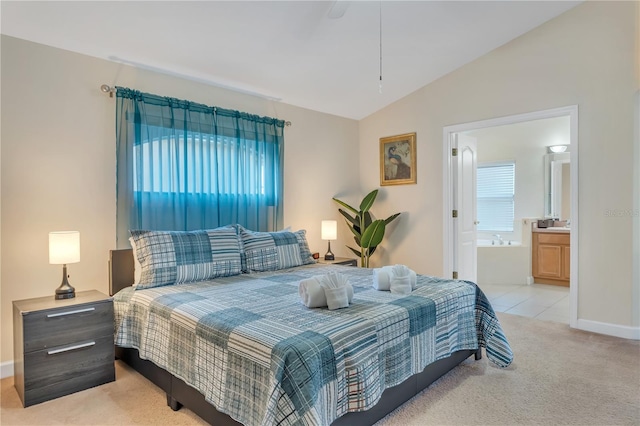 620 Old Bridge Cir, Davenport, FL 33897 - bedroom featuring light carpet, lofted ceiling, ensuite bathroom, and baseboards