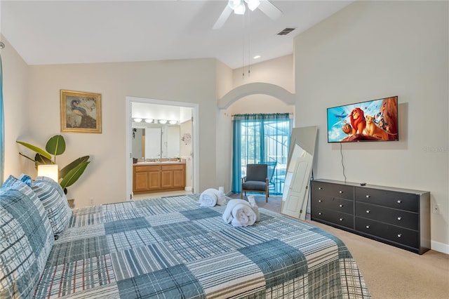 620 Old Bridge Cir, Davenport, FL 33897 - bedroom with arched walkways, light carpet, baseboards, connected bathroom, and ceiling fan