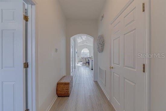 926 Balmoral Dr, Davenport, FL 33896 - hall with wood finished floors, baseboards, and arched walkways