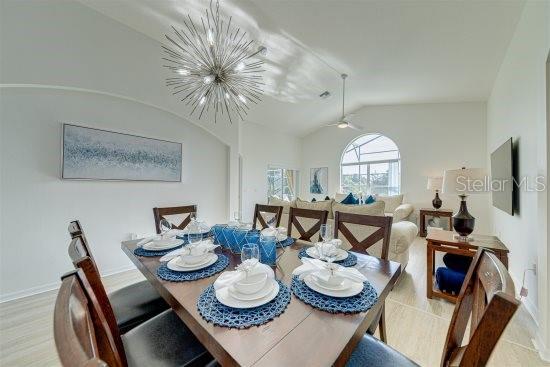 926 Balmoral Dr, Davenport, FL 33896 - dining room with lofted ceiling, a chandelier, and baseboards