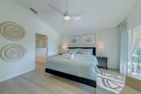 926 Balmoral Dr, Davenport, FL 33896 - bedroom with lofted ceiling, wood finished floors, ceiling fan, and baseboards