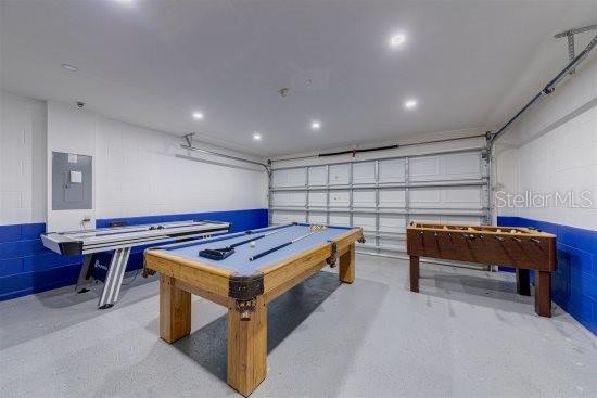 926 Balmoral Dr, Davenport, FL 33896 - rec room featuring electric panel, concrete floors, a garage, and recessed lighting