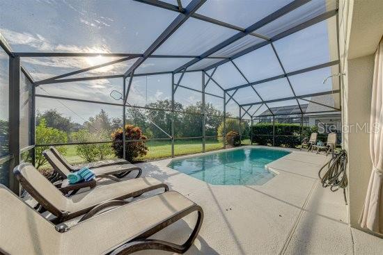 926 Balmoral Dr, Davenport, FL 33896 - outdoor pool with a patio and glass enclosure