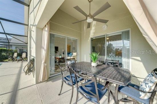 926 Balmoral Dr, Davenport, FL 33896 - view of patio / terrace featuring ceiling fan, a lanai, and outdoor dining space