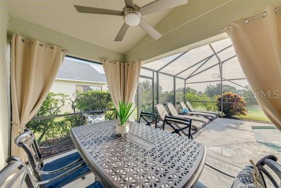 926 Balmoral Dr, Davenport, FL 33896 - view of patio / terrace featuring a ceiling fan, glass enclosure, and outdoor dining area