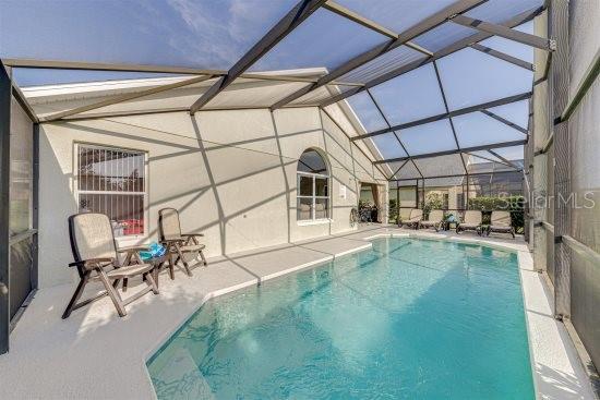926 Balmoral Dr, Davenport, FL 33896 - outdoor pool with a patio and a lanai