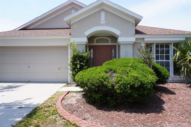 10308 Soaring Eagle Dr, Riverview, FL 33578 - view of front of property featuring a shingled roof, a garage, stucco siding, and concrete driveway