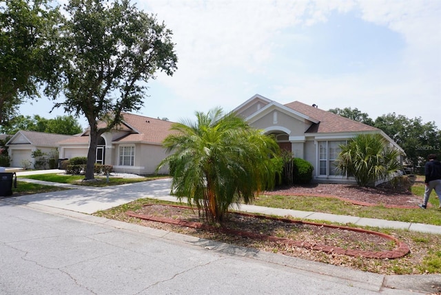 10308 Soaring Eagle Dr, Riverview, FL 33578 - view of front facade featuring a garage, concrete driveway, and stucco siding