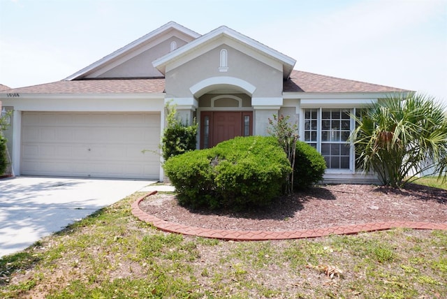 10308 Soaring Eagle Dr, Riverview, FL 33578 - view of front facade with concrete driveway, a garage, a shingled roof, and stucco siding
