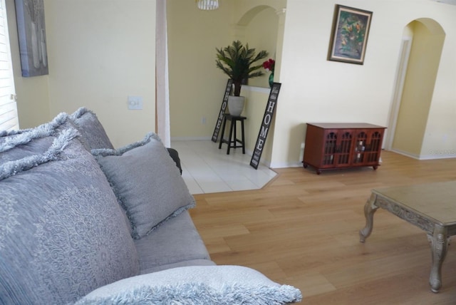 10308 Soaring Eagle Dr, Riverview, FL 33578 - living room featuring arched walkways, wood finished floors, and baseboards
