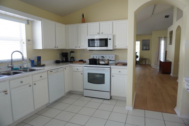 10308 Soaring Eagle Dr, Riverview, FL 33578 - kitchen with white appliances, a sink, arched walkways, light countertops, and lofted ceiling