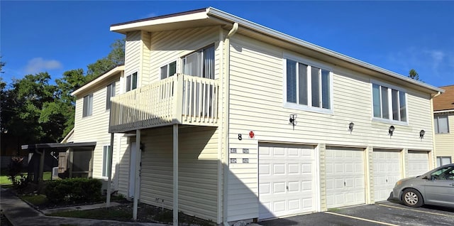1024 Spring Meadow Dr, Kissimmee, FL 34741 - view of home's exterior with a balcony, a garage, and asphalt driveway
