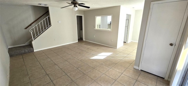 1024 Spring Meadow Dr, Kissimmee, FL 34741 - spare room with light tile patterned floors, a ceiling fan, stairway, baseboards, and a textured ceiling