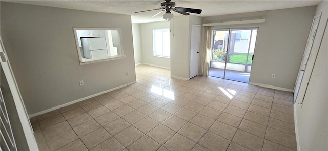 1024 Spring Meadow Dr, Kissimmee, FL 34741 - unfurnished room featuring light tile patterned floors, baseboards, ceiling fan, and a textured ceiling
